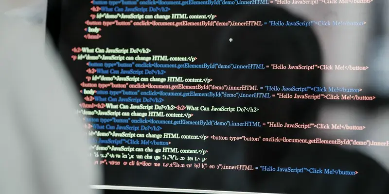 Close-up of source code on a screen, reflected in a pair of glasses.
